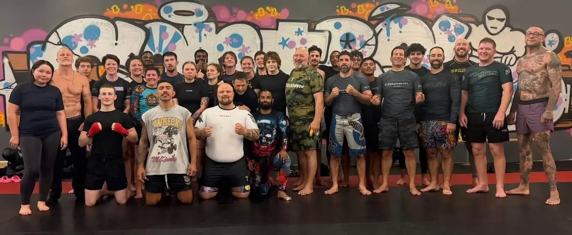 Control Jiu Jitsu students and coaches standing together after training