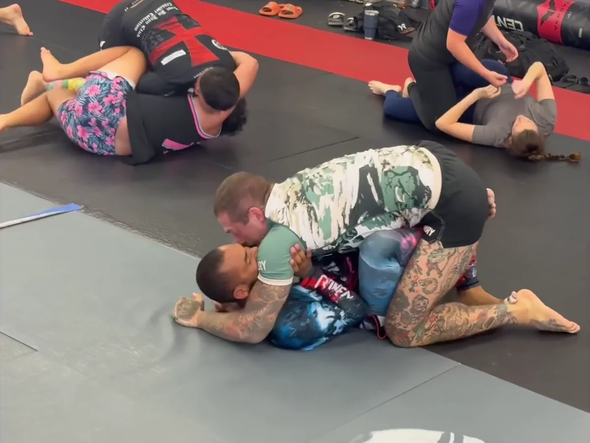 Training partners practicing Jiu-Jitsu on the mat at Control